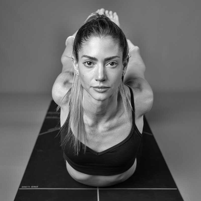 Shira Gavish in a seated stretch during a yoga class — Shira Gavish yoga in Tenafly & Bergen County, NJ