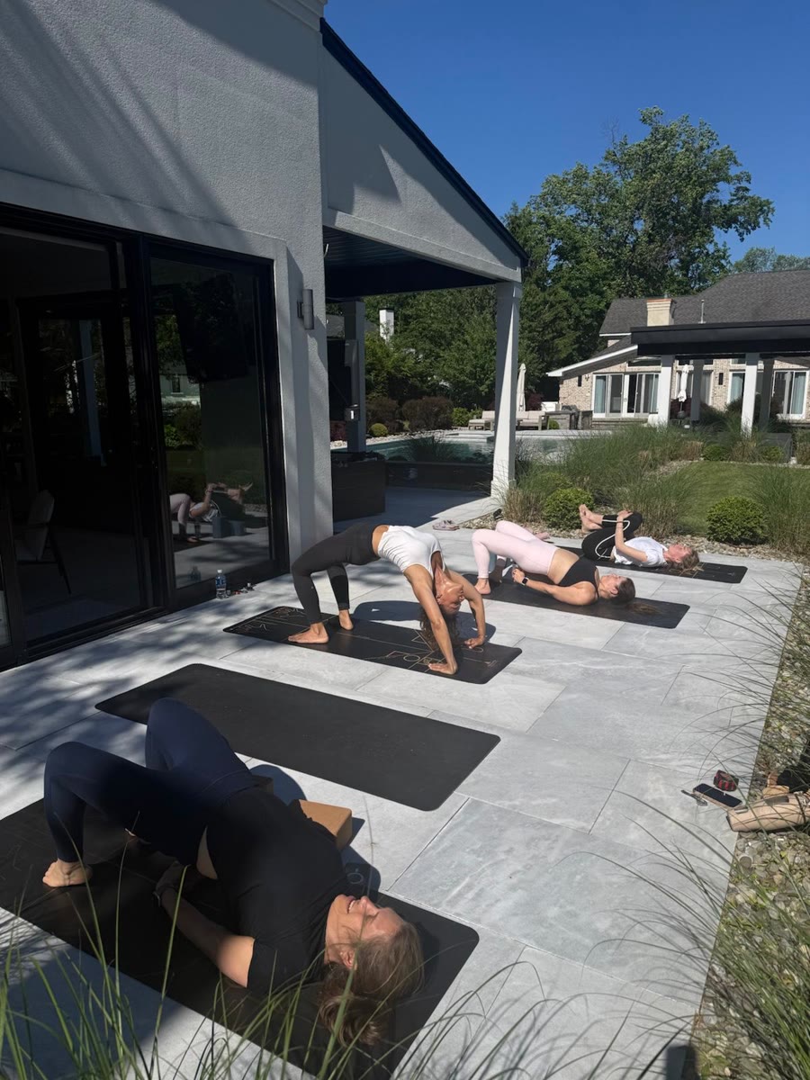 Students in headstand during a group class
